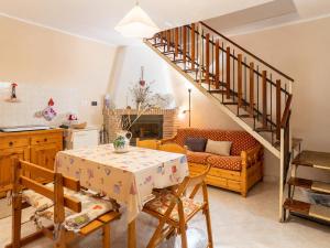 a living room with a table and a staircase at La Dimora Sulla Collina Micciani Rieti in Micciani