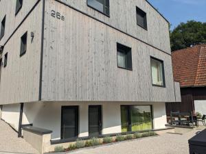 a building clad in wood with windows at Fewo New Oberdorf in Fautenbach