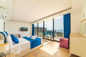 a bedroom with a bed and a large window at Villa Panorama Kalkan Jilda Livya in Kalkan