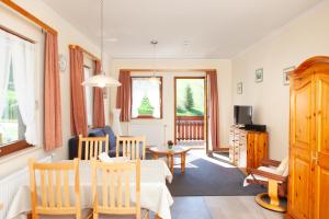 a living room with a table and a dining room at Haus Keller Ferienwohnungen in Todtnauberg