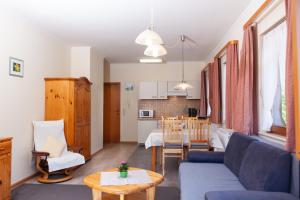 a living room with a couch and a table at Haus Keller Ferienwohnungen in Todtnauberg
