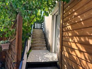 a stairway leading up to a house with a building at Appartement spacieux et lumineux proche gare in Ambérieu-en-Bugey +3 photos