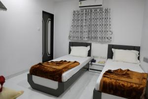 Postel nebo postele na pokoji v ubytování Hotel Pearl