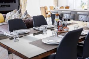 a table with plates and glasses and bottles on it at Grangebeg B&B Dunlavin W91FK50 in Dún Luáin