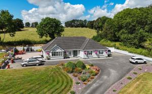 an aerial view of a house with cars parked in a driveway at Grangebeg B&B Dunlavin W91FK50 in Dún Luáin