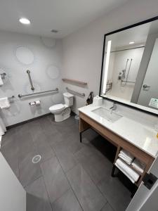 a bathroom with a sink and a toilet and a mirror at Tru By Hilton Bellefonte in Bellefonte +13 photos