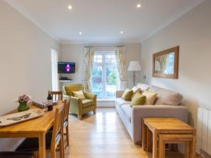 a living room with a couch and a table at Milntown Self Catering Apartments in Ramsey
