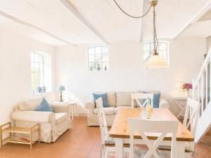 a living room with a couch and a table at Emes Stuuv in Oevenum