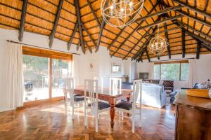 a dining room with a table and chairs at Ambleside Cottage in Underberg