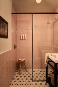 a shower with a glass door in a bathroom at The June Motel, Prince Edward County in Picton