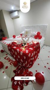 a bedroom with a bed covered in blood on the floor at ORO - Boutique Guesthouse in Matola +16 photos