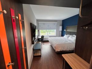 a hotel room with a bed and a window at Tru By Hilton Bellefonte in Bellefonte