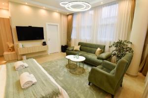 a living room with a couch and a tv at Dream Palace 2 in Belgrade