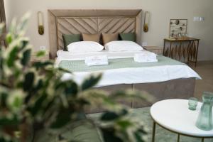 a bedroom with a bed with two towels on it at Dream Palace 2 in Belgrade