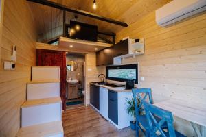a kitchen in a tiny house with a counter and a sink at Tiny House Dolinky in Veľká Lesná