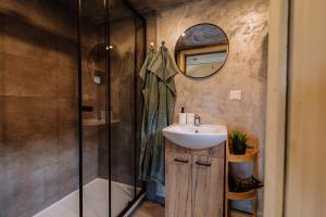 a bathroom with a sink and a shower at Tiny House Dolinky in Veľká Lesná
