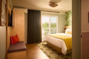 a bedroom with a bed and a large window at The June Motel, Prince Edward County in Picton