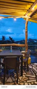 a table and chairs on a patio with a tree at CO Casa Ocean in Juan de Acosta