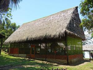 a large building with a thatched roof at Amazon Lodge and Expeditions in Iquitos