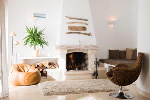 a living room filled with furniture and a fire place at Laneez Ericeira Surf House in Ericeira