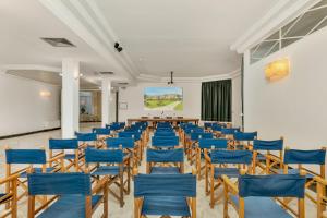 a room with blue chairs and a table in it at Hotel Villa Undulna - Terme della Versilia in Cinquale +127 photos