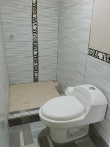 a bathroom with a white toilet in a room at Amazon Lodge and Expeditions in Iquitos