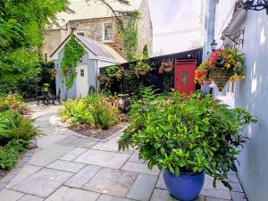 a garden with flowers and plants in front of a building at Herlihy's in Farranfore