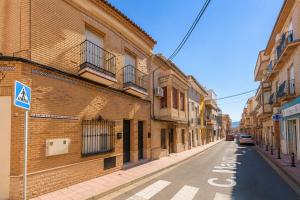 an empty street in a city with buildings at Coliving San Esteban in La Ñora