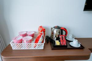 a table with a tray of drinks and a coffee maker at Thành Danh Hotel in Dong Hoi