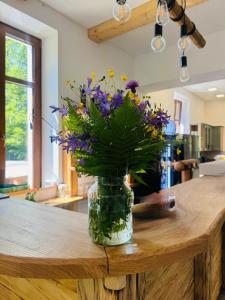 a vase filled with flowers sitting on a table at Celnice pod Sněžníkem-Nová Seninka in Staré Město
