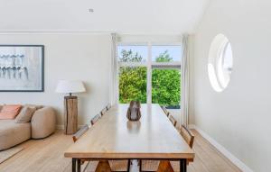 a living room with a table and a couch at Villa By The Sea in Bergen aan Zee