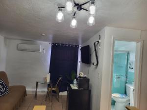 a living room with a ceiling fan and a table at Coco Sol 3 by MyMiamiStay in Miami +38 photos