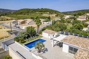 an aerial view of a house with a swimming pool at Villa Terre Des Vins by Villa Plus in Portel-des-Corbières