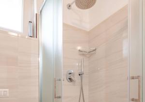a shower with a glass door in a bathroom at Civico4 - Osteria Varanalle in Ariano Irpino +38 photos