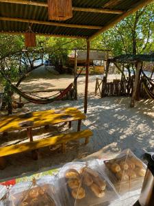 a group of picnic tables with bags of bread at DuMangue Kite House in Guriú