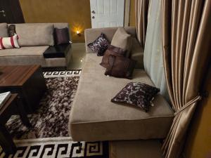 a couch with pillows on it in a living room at TwinVilleCove, affordable villas located in Ajah in Aja