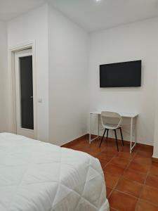 a bedroom with a bed and a table and a television at Dream Rooms Palomonte 