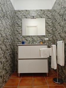 a bathroom with a sink and a mirror and towels at Dream Rooms Palomonte 