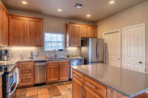 a kitchen with wooden cabinets and stainless steel appliances at Happy Heron in Port Aransas