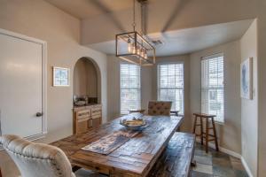 a dining room with a wooden table and chairs at Happy Heron in Port Aransas