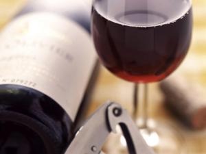 a glass of red wine next to a wine bottle at ibis Rio de Janeiro Centro in Rio de Janeiro