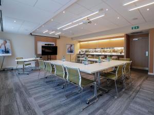 a conference room with a large table and chairs at Novotel Luxembourg Centre in Luxembourg