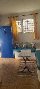 a room with a table and a blue desk at Dolce in Hammamet Sud