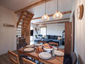 a dining room with a table with food on it at SierPlejs Hill - domki przy szlaku w Górach Sowich in Sierpnica