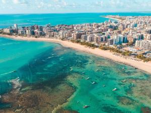an aerial view of a beach and a city at Mercure Maceio Pajuçara in Maceió