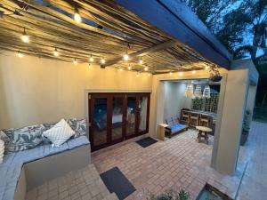 a patio with a couch and a table and lights at The Bryanston Boutique in Johannesburg
