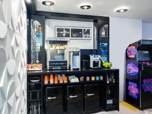 a coffee shop with a counter with a coffee maker at Ibis Styles Strasbourg Centre Gare in Strasbourg
