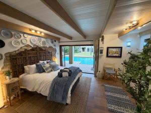 a bedroom with a large bed with a wooden headboard at The Bryanston Boutique in Johannesburg +63 photos