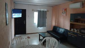 a living room with a couch and a table and chairs at Olivia in Paysandú