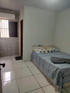a bedroom with a bed and a flat screen tv at Hotel Boneario in Vitória da Conquista +15 photos